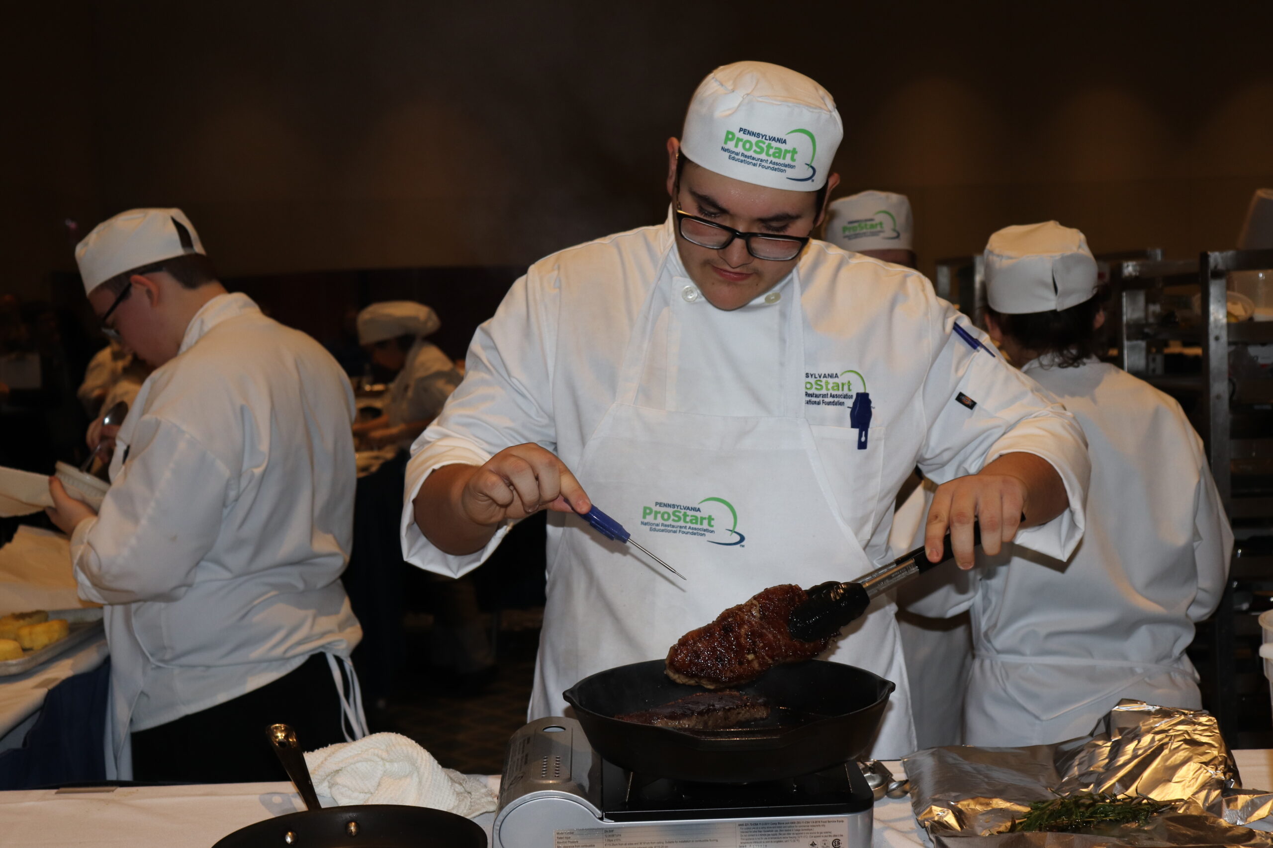 A ProStart student cooking.